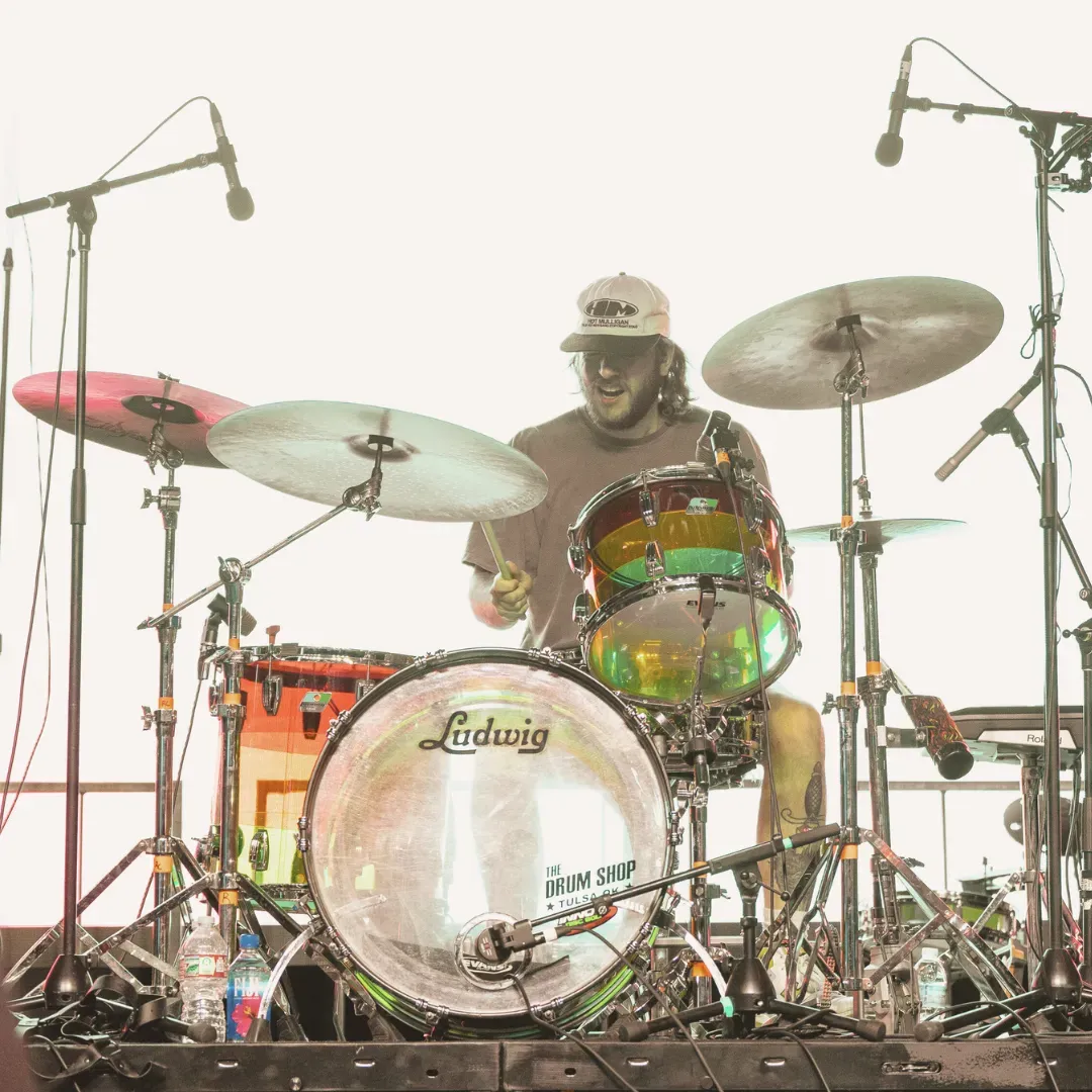 Drummer performing at a live concert